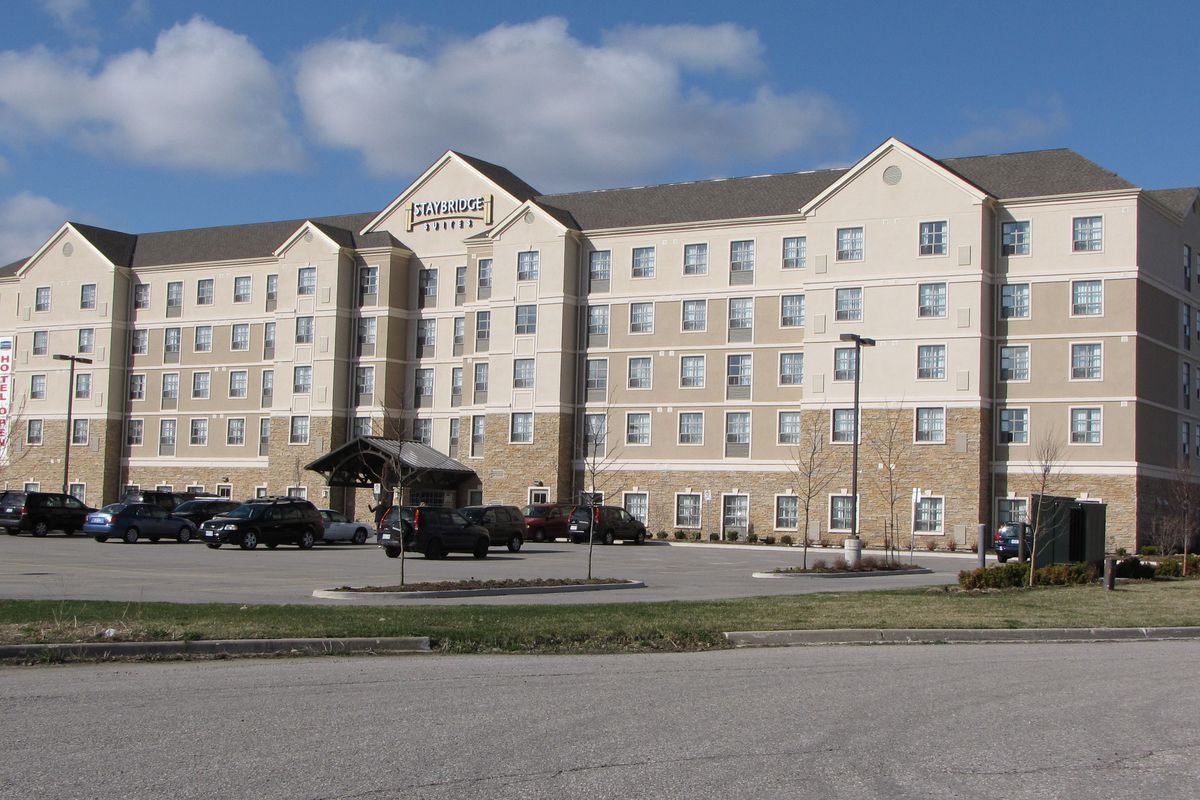 Exterior of Staybridge Suites Guelph, a six-storey hotel with a covered entrance