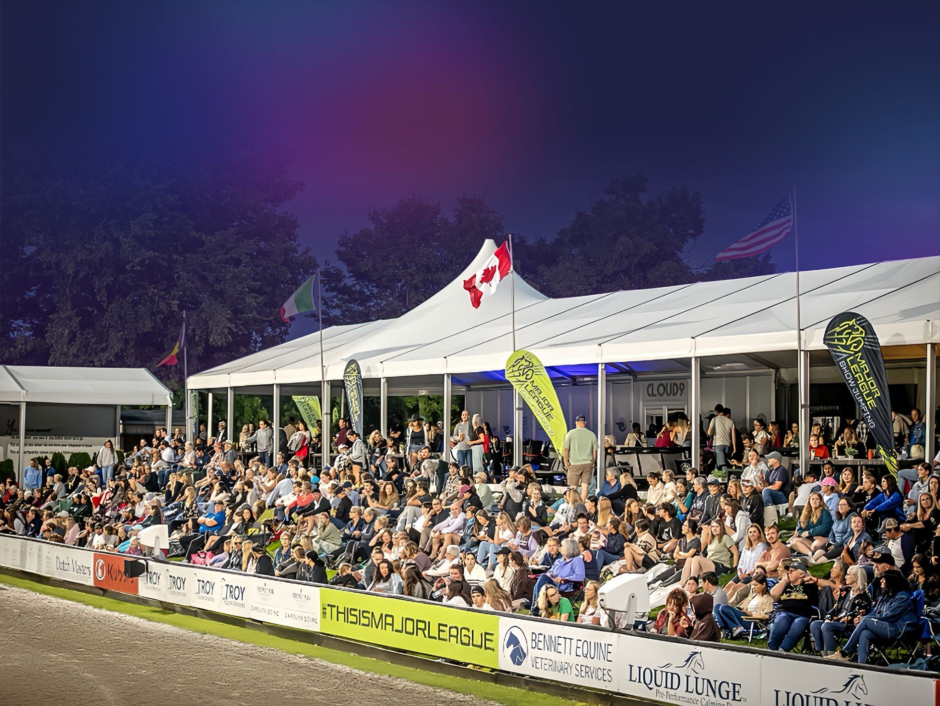 Spectators in the grandstand and hospitality tents at an Angelstone Grand Prix
