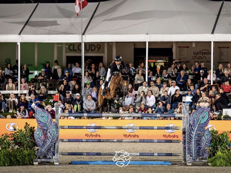 Night jump over the Kubota fence in front of a packed tent at MLSJ Toronto